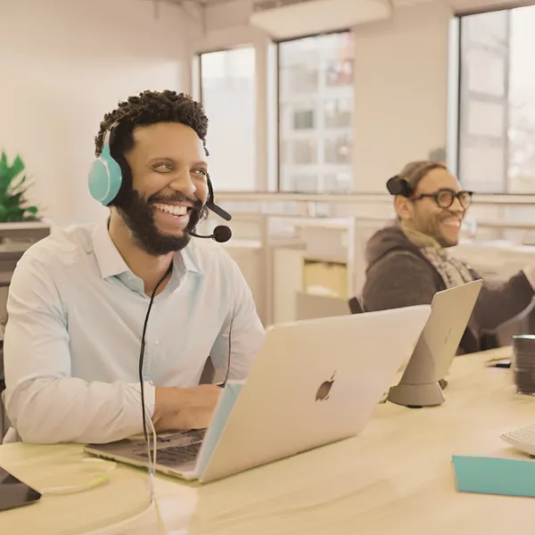 Smiling professional with headset in office setting